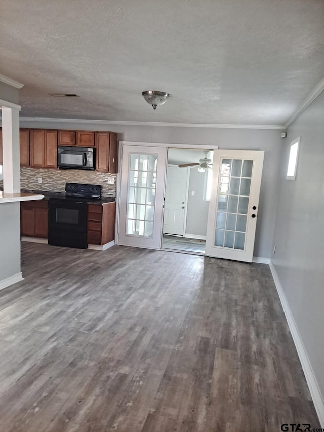 3107 Hamilton Ln, Texarkana, TX 75501 - kitchen with black appliances, ornamental molding, brown cabinetry, dark wood-style flooring, and a textured ceiling