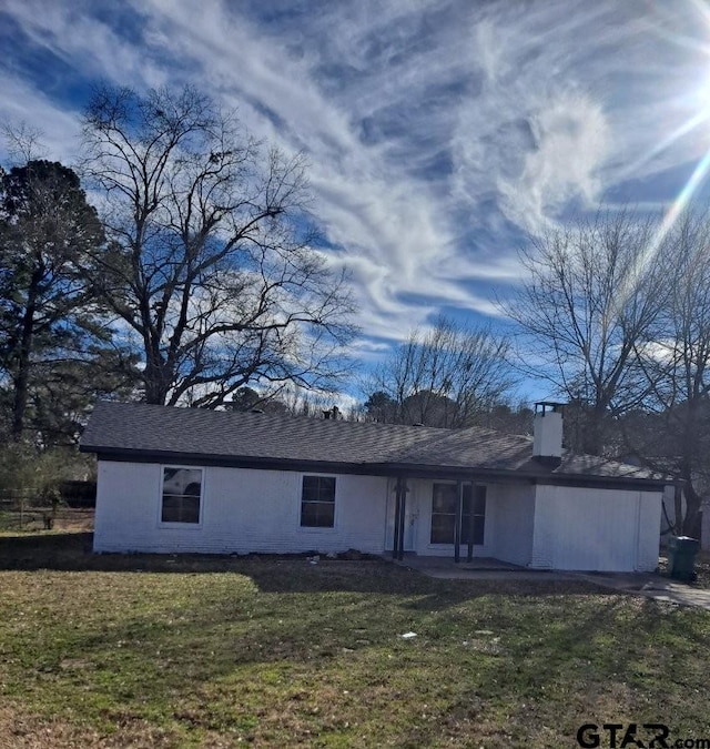 3107 Hamilton Ln, Texarkana, TX 75501 - rear view of property with a chimney and a lawn