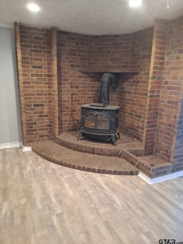 3107 Hamilton Ln, Texarkana, TX 75501 - detailed view of wood finished floors, a wood stove, baseboards, and recessed lighting