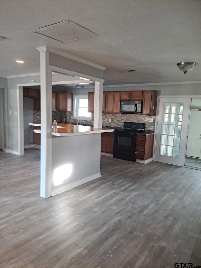 3107 Hamilton Ln, Texarkana, TX 75501 - kitchen with black appliances, crown molding, brown cabinetry, decorative backsplash, and dark wood-style floors