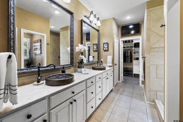 11187 Hunters Trl, Flint, TX 75762 - bathroom featuring tile patterned floors, double vanity, a tile shower, a spacious closet, and recessed lighting