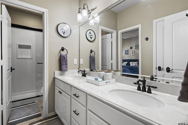 11187 Hunters Trl, Flint, TX 75762 - ensuite bathroom featuring double vanity, a stall shower, and tile patterned floors