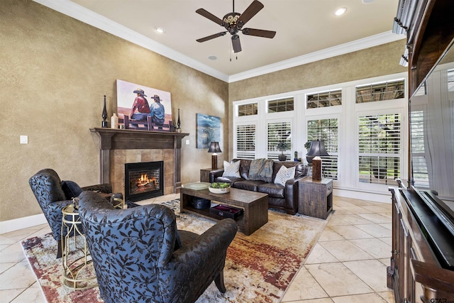 11187 Hunters Trl, Flint, TX 75762 - living area featuring a textured wall, ceiling fan, a tiled fireplace, crown molding, and light tile patterned floors