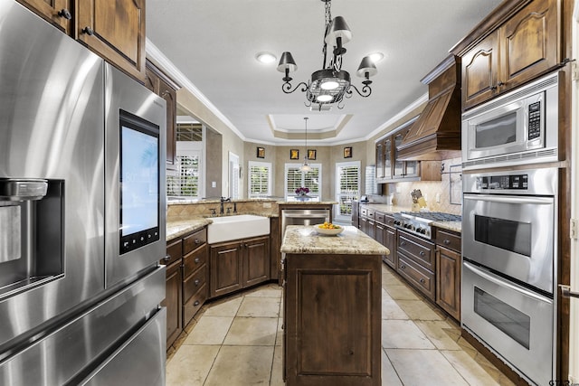 11187 Hunters Trl, Flint, TX 75762 - kitchen featuring stainless steel appliances, crown molding, a peninsula, backsplash, and hanging light fixtures
