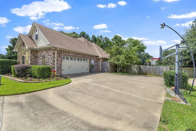 11187 Hunters Trl, Flint, TX 75762 - view of side of property with brick siding, driveway, a shingled roof, and an attached garage