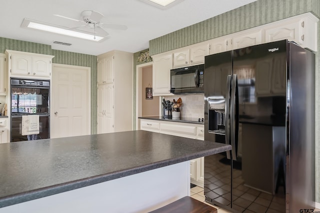 kitchen featuring light tile patterned flooring, white cabinetry, ceiling fan, and black appliances