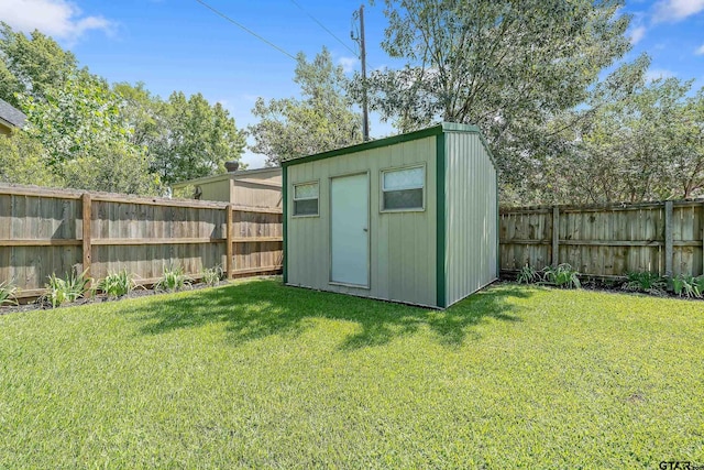 view of outdoor structure featuring a lawn