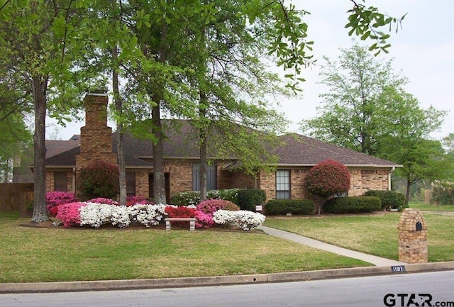 single story home with a front lawn