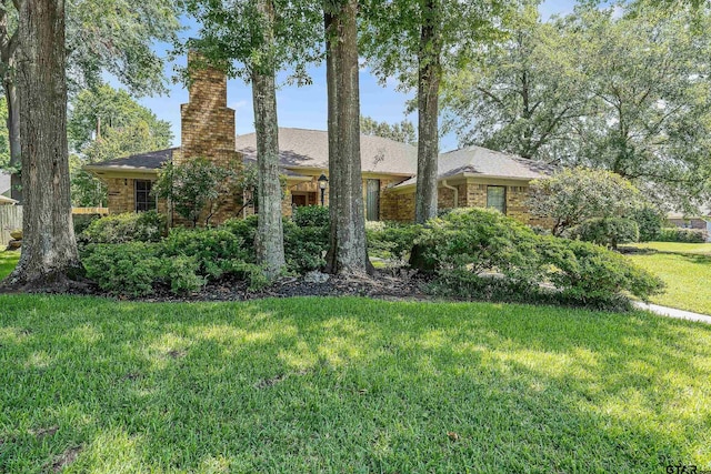 ranch-style home with a front lawn