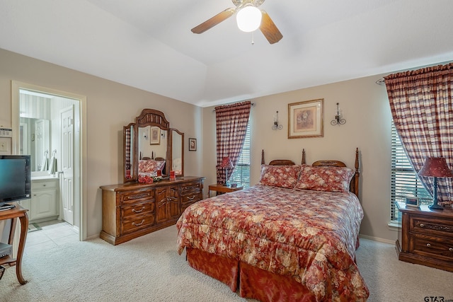 carpeted bedroom featuring ensuite bath and ceiling fan