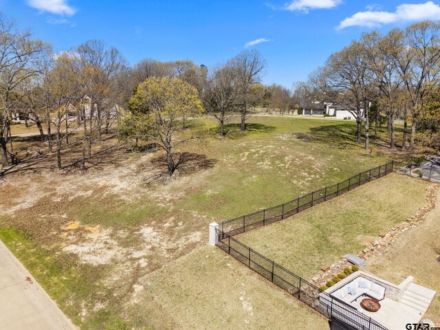 view of yard featuring fence and a rural view