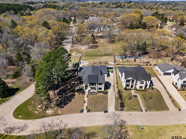 drone / aerial view featuring a wooded view