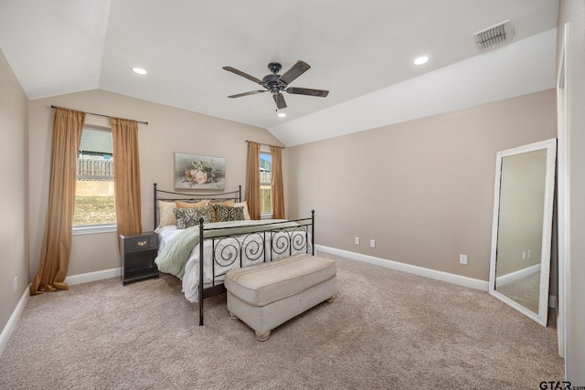 bedroom with vaulted ceiling, light colored carpet, and ceiling fan