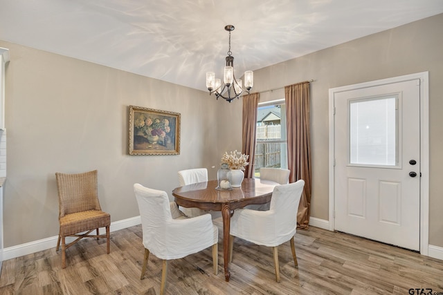 dining space featuring a notable chandelier and light hardwood / wood-style flooring