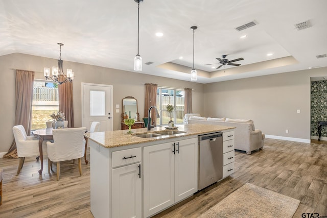 kitchen featuring sink, an island with sink, stainless steel dishwasher, white cabinetry, and light wood-type flooring