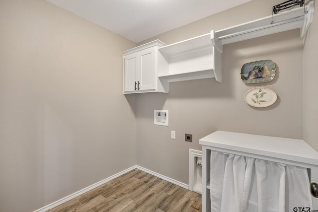 laundry room with light wood-type flooring, cabinets, hookup for a washing machine, and hookup for an electric dryer