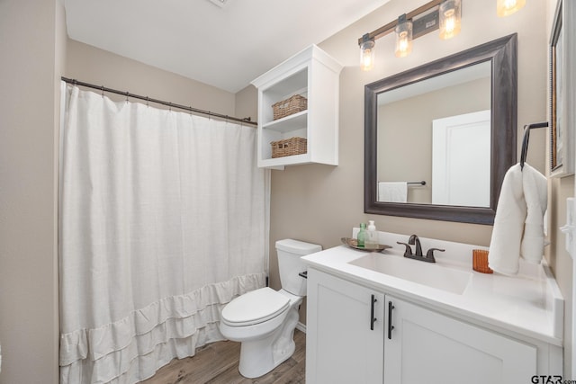 bathroom featuring hardwood / wood-style floors, vanity, and toilet