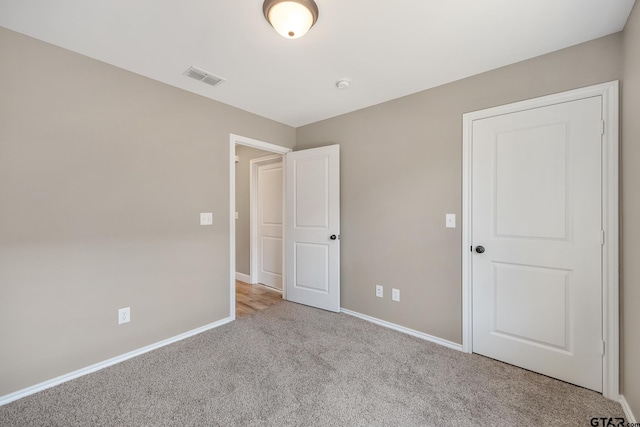 unfurnished bedroom with light colored carpet