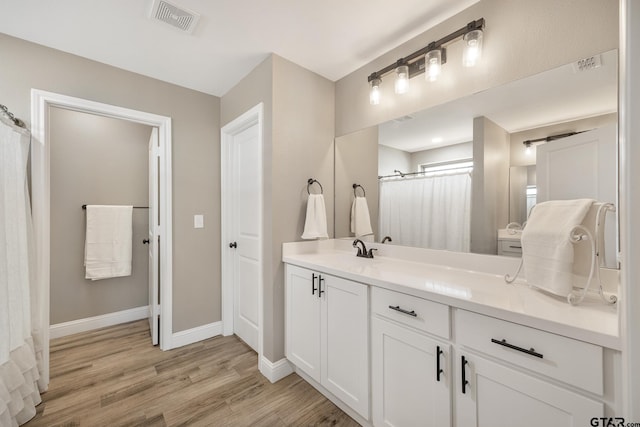 bathroom with hardwood / wood-style flooring and vanity