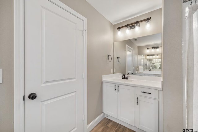 bathroom with hardwood / wood-style floors and vanity