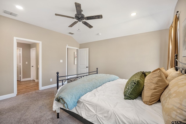 bedroom with ceiling fan, light carpet, and lofted ceiling