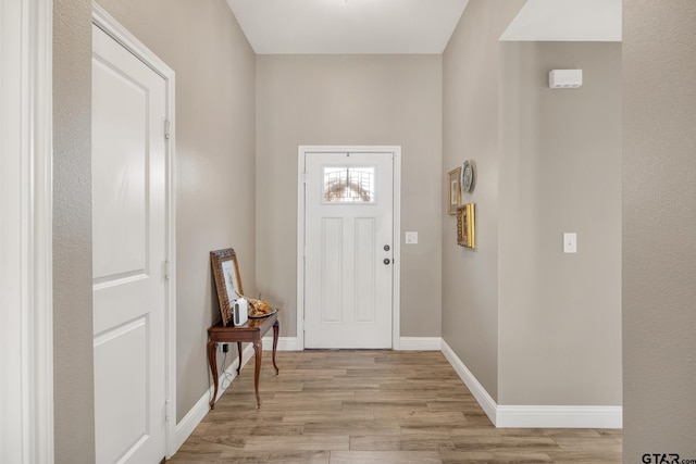 foyer entrance with light hardwood / wood-style floors