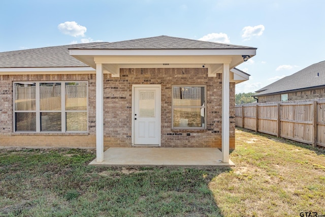 rear view of property with a patio area and a yard