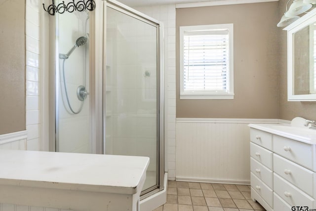 310 Windridge Rd, Palestine, TX 75801 - full bath with vanity, wainscoting, a shower stall, and tile patterned flooring