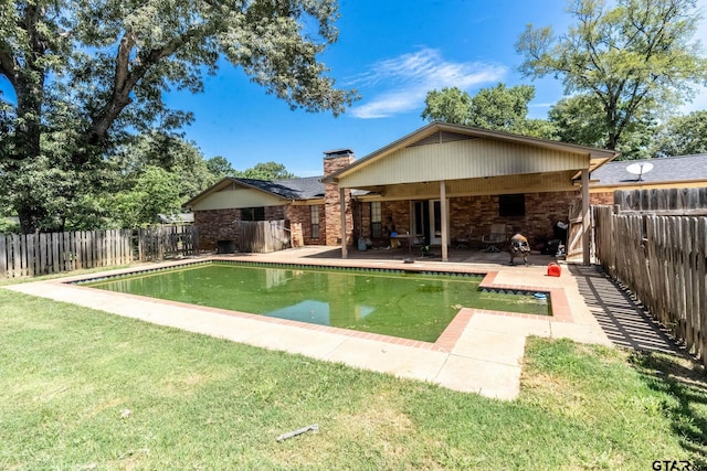 310 Windridge Rd, Palestine, TX 75801 - rear view of house featuring a chimney, a patio, a fenced backyard, and brick siding