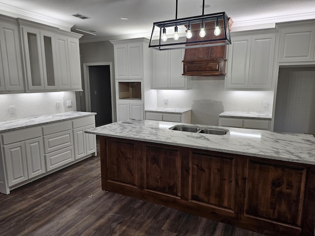 105 Johnston St, Arp, TX 75750 - kitchen with crown molding, dark wood finished floors, light stone countertops, pendant lighting, and white cabinetry