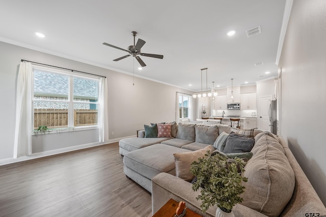 137 Sides Blvd, Bullard, TX 75757 - living area with healthy amount of natural light, a ceiling fan, wood finished floors, ornamental molding, and recessed lighting