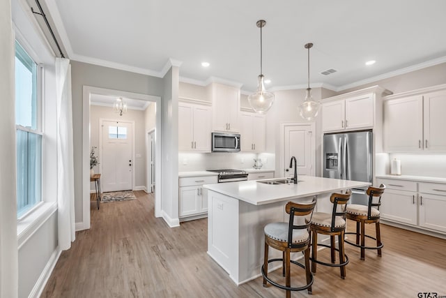 137 Sides Blvd, Bullard, TX 75757 - kitchen featuring appliances with stainless steel finishes, a sink, a center island with sink, white cabinetry, and light countertops