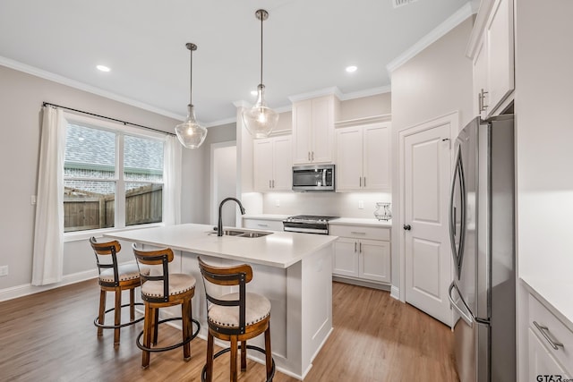 137 Sides Blvd, Bullard, TX 75757 - kitchen featuring appliances with stainless steel finishes, a sink, white cabinetry, light wood-style flooring, and ornamental molding