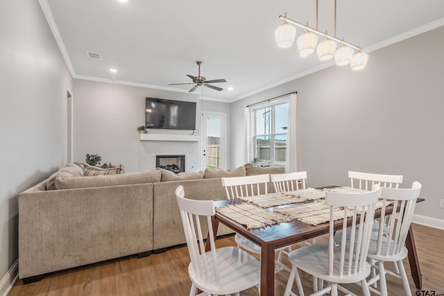 137 Sides Blvd, Bullard, TX 75757 - dining area featuring crown molding, a ceiling fan, a fireplace, wood finished floors, and baseboards