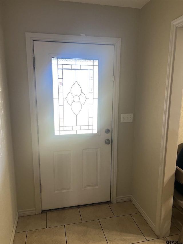 doorway featuring light tile patterned floors and a wealth of natural light