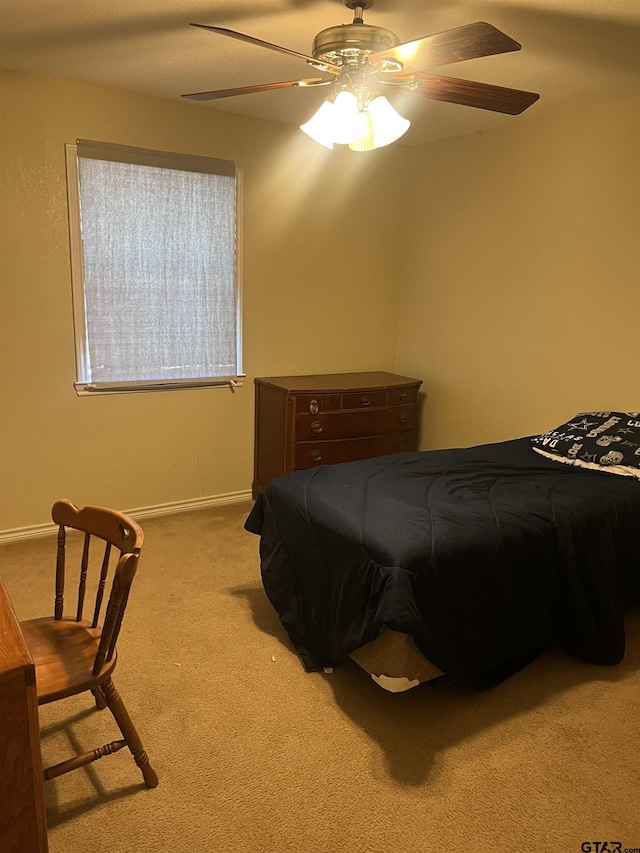 bedroom featuring light colored carpet and ceiling fan