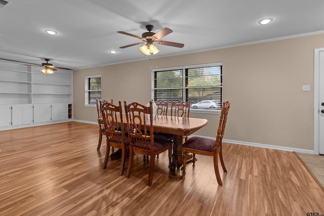 dining space with ornamental molding, light hardwood / wood-style floors, and ceiling fan