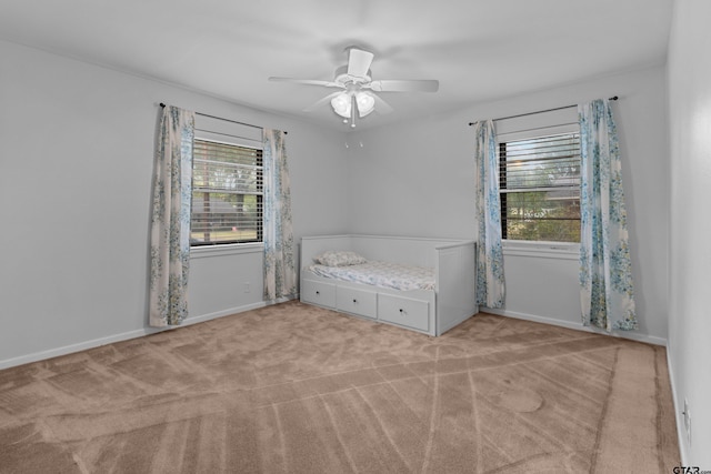 unfurnished bedroom featuring ceiling fan and light carpet