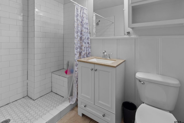 bathroom with vanity, tile patterned floors, toilet, and a shower with curtain