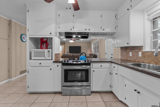 kitchen with light tile patterned flooring, white cabinetry, sink, stainless steel range with electric stovetop, and decorative backsplash