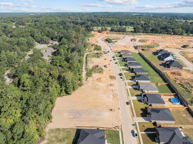 birds eye view of property with a residential view and a view of trees