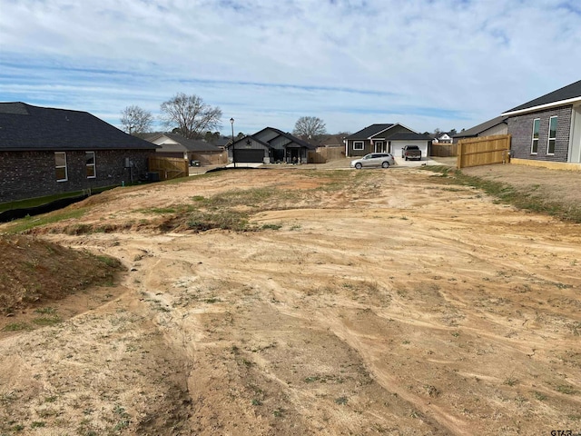 view of yard featuring a residential view and fence