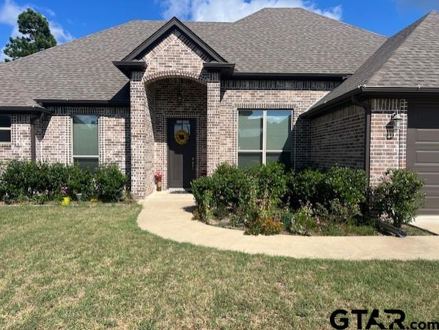 view of front of house with a garage and a front lawn