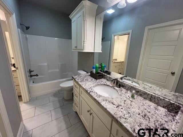 full bathroom featuring tile patterned flooring, shower / washtub combination, vanity, and toilet