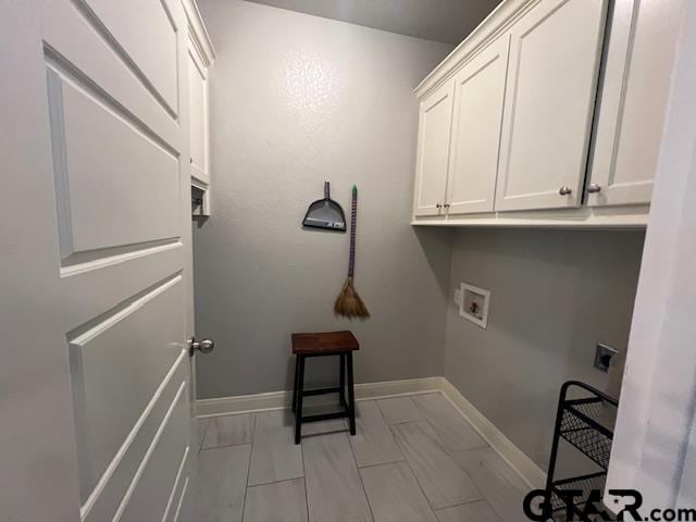 washroom featuring electric dryer hookup, cabinets, and washer hookup