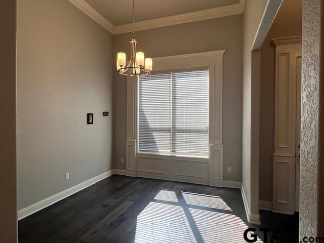 unfurnished dining area with dark hardwood / wood-style flooring, an inviting chandelier, plenty of natural light, and ornamental molding