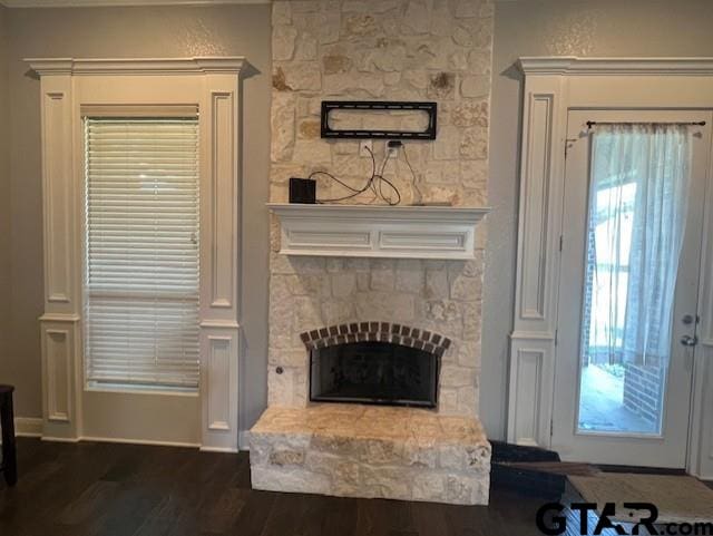 living room with dark hardwood / wood-style flooring and a fireplace