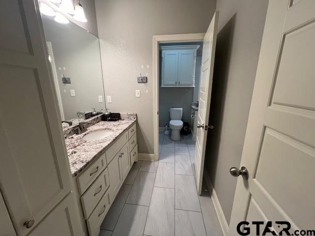 bathroom with vanity and toilet