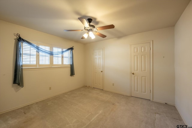 unfurnished bedroom with light carpet and ceiling fan