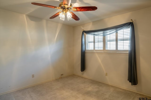 spare room featuring light colored carpet